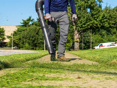Worker Cleans Up Path Leaf Blower